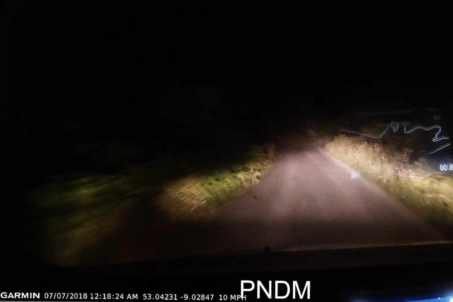 Footage from our dashcam at night, where the road is completely black except for the small area illuminated by our headlights