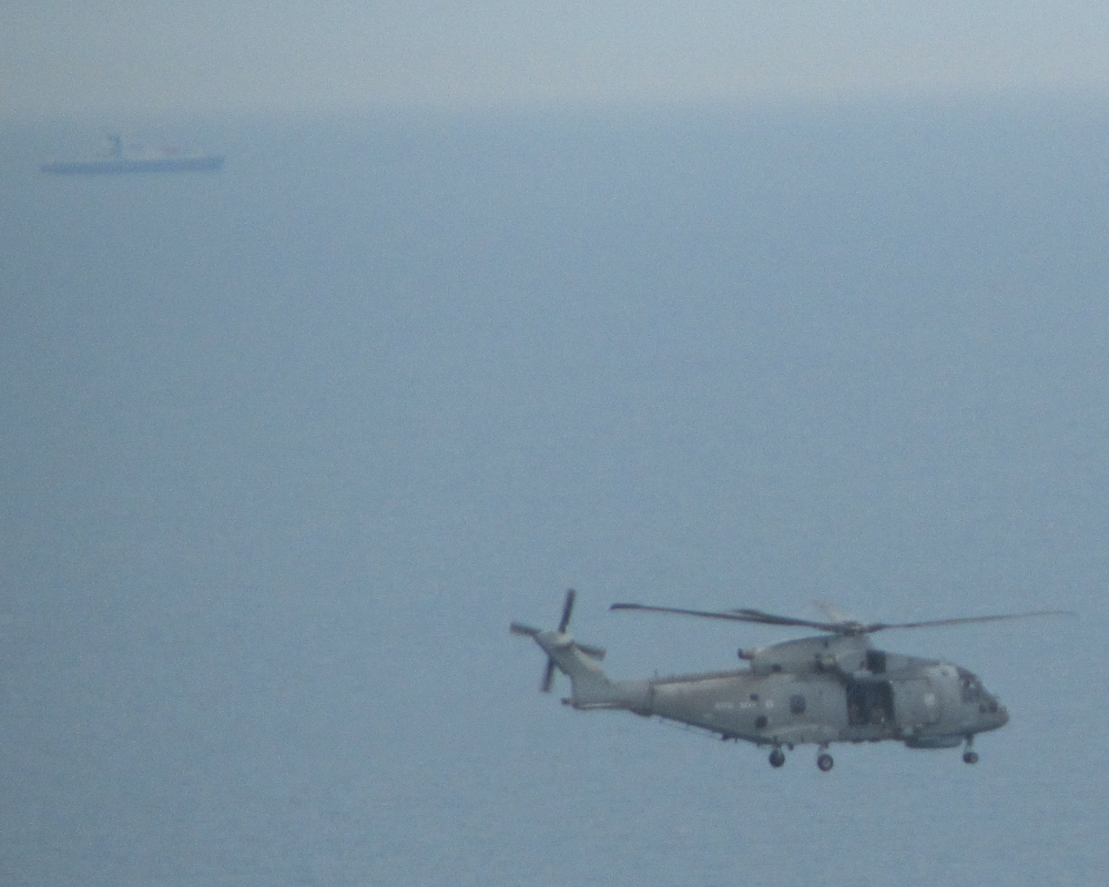 Military helicopter over the sea