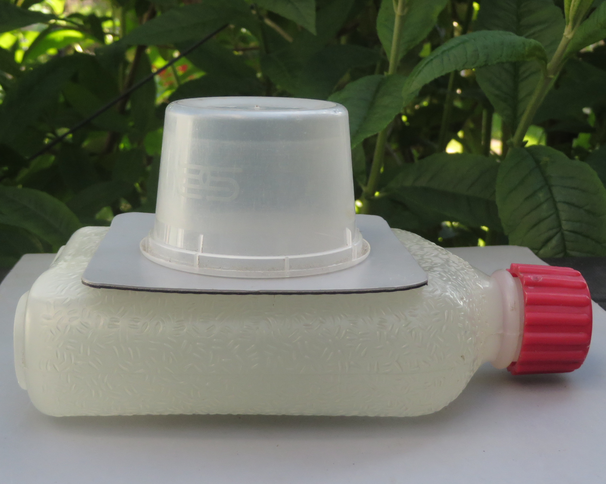 Upside pot resting on a bottle containing frozen water